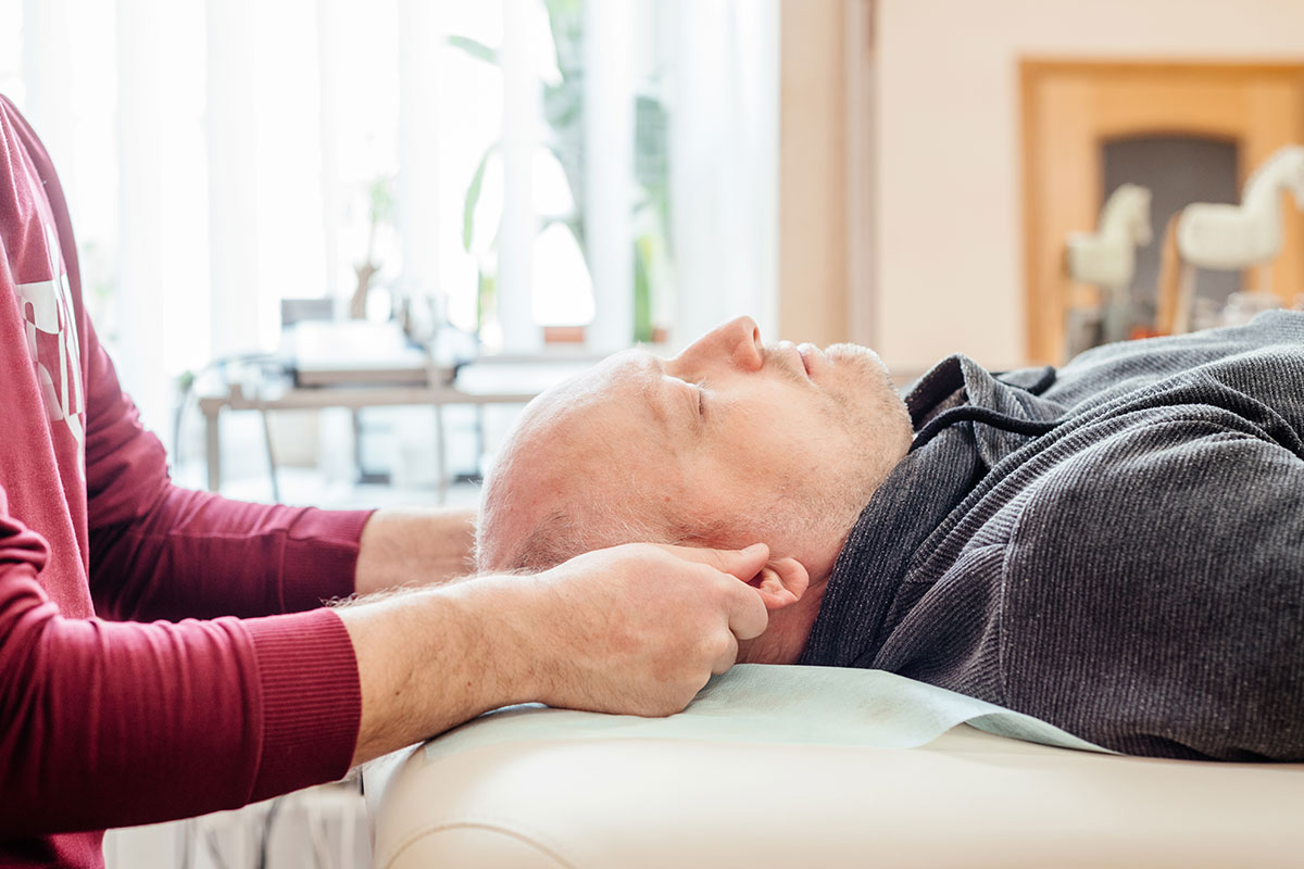 Patient on table with physician try to realign the head.