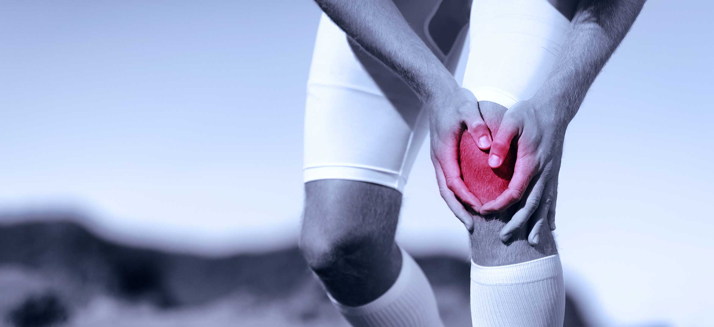 A man touching knee at pain point.
