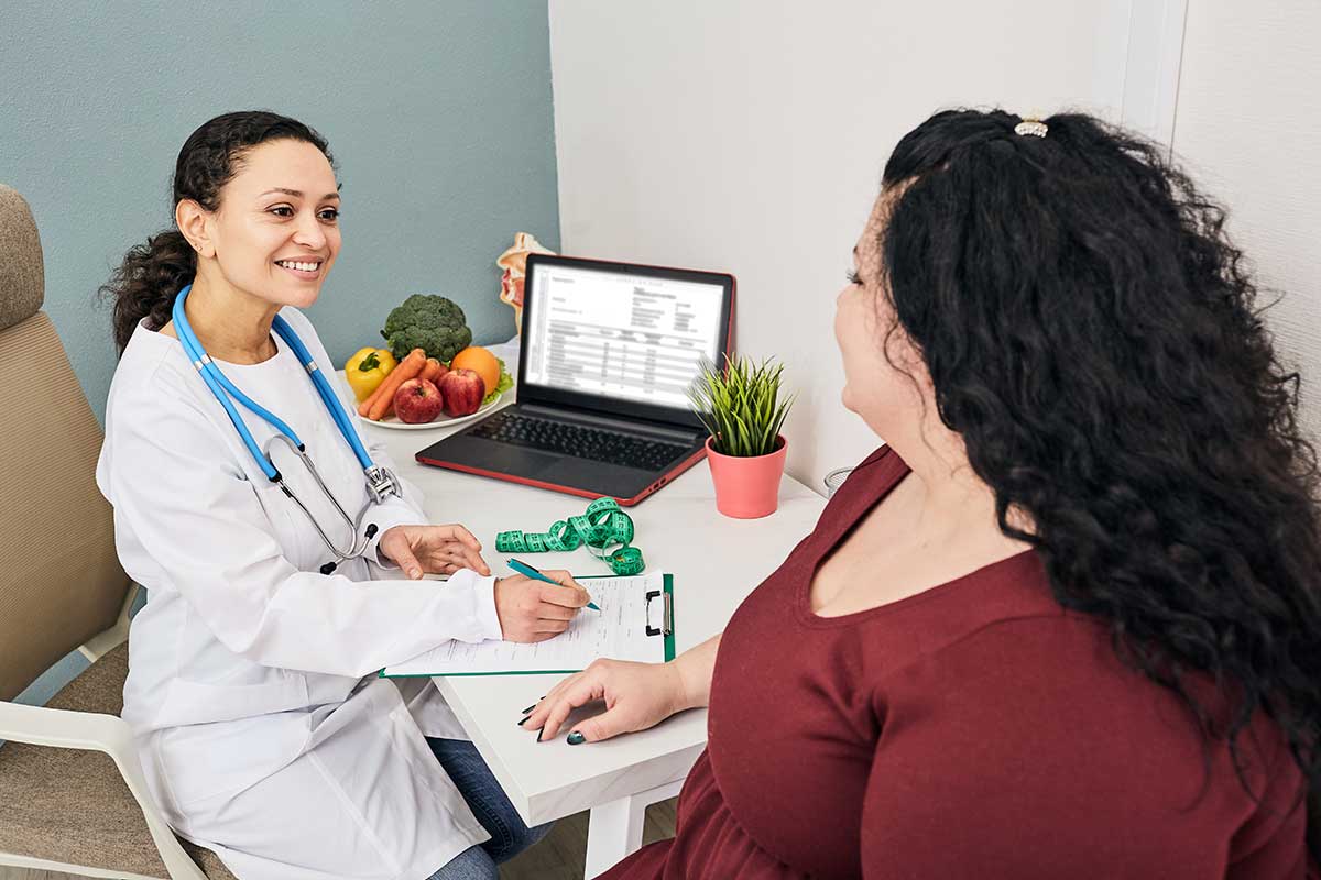 Dietitian a prepares meal plan for a female patient