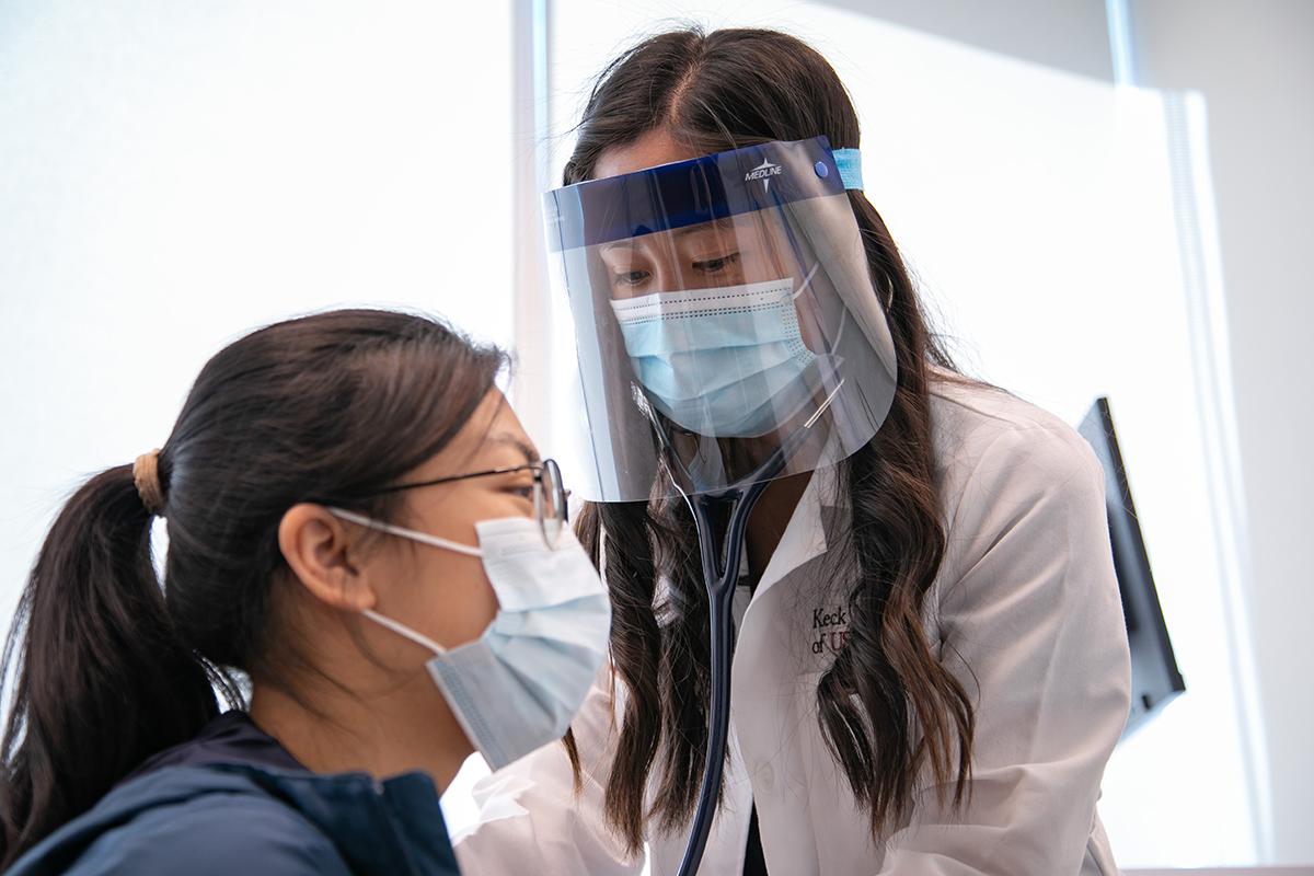 Keck Medicine of USC doctor examines a female patient