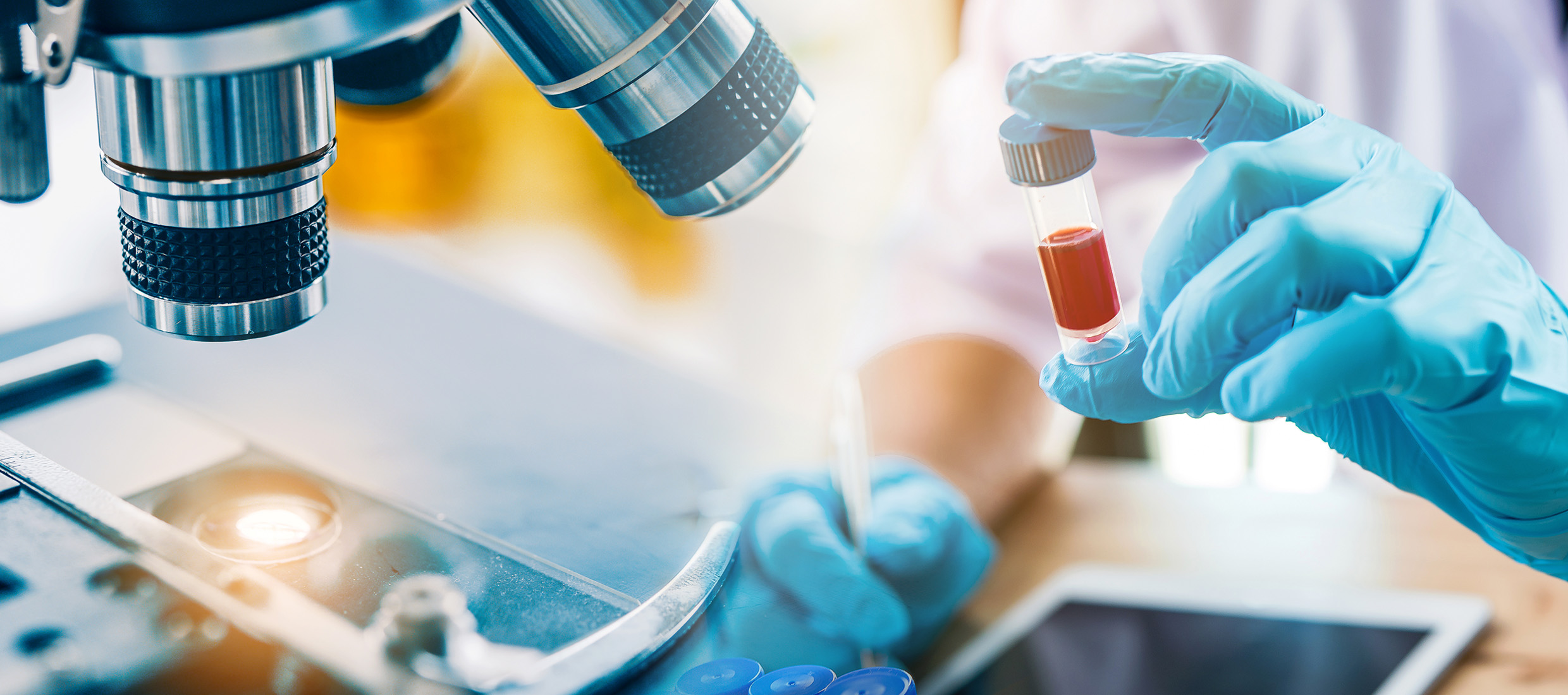 Hands of scientist holding a vial in a laboratory