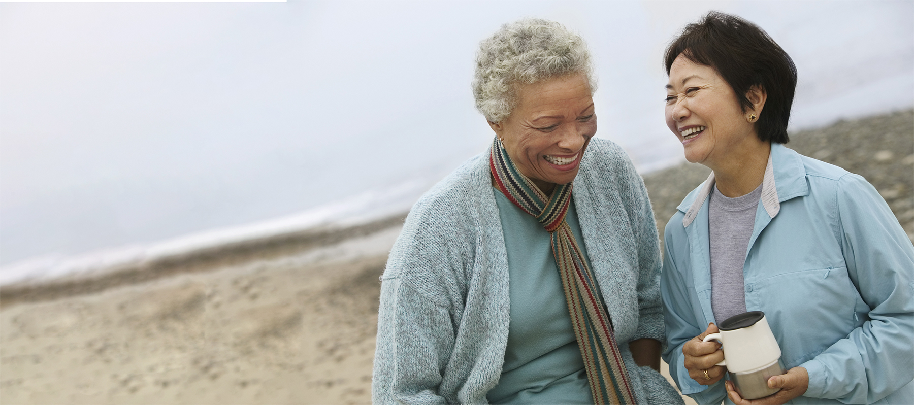 Two smiling women stand together