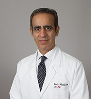 A portrait of Dr. Chaudhary.