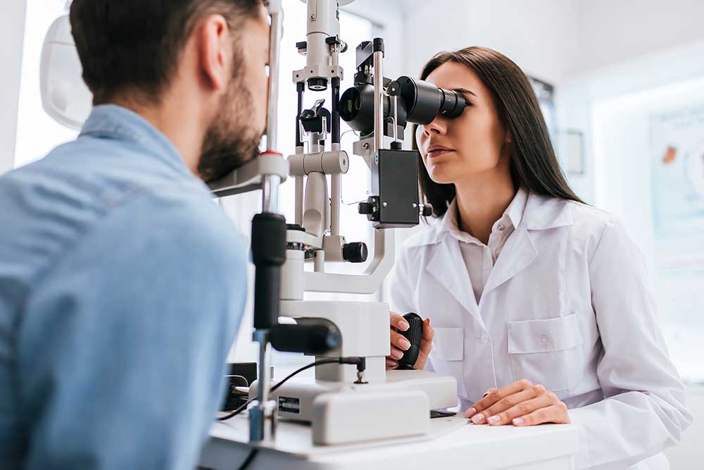 Female ophthalmologist checks a patient’s eyes during a vision examination