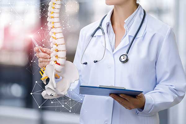 A spine care medical specialist shows a computerized model of the spine