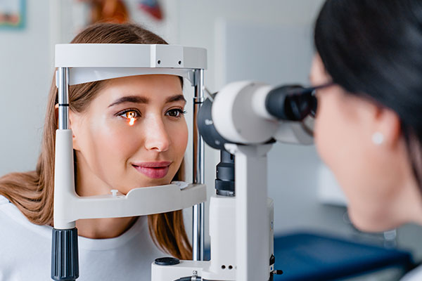 Eye doctor with female patient during an examination in modern clinic.