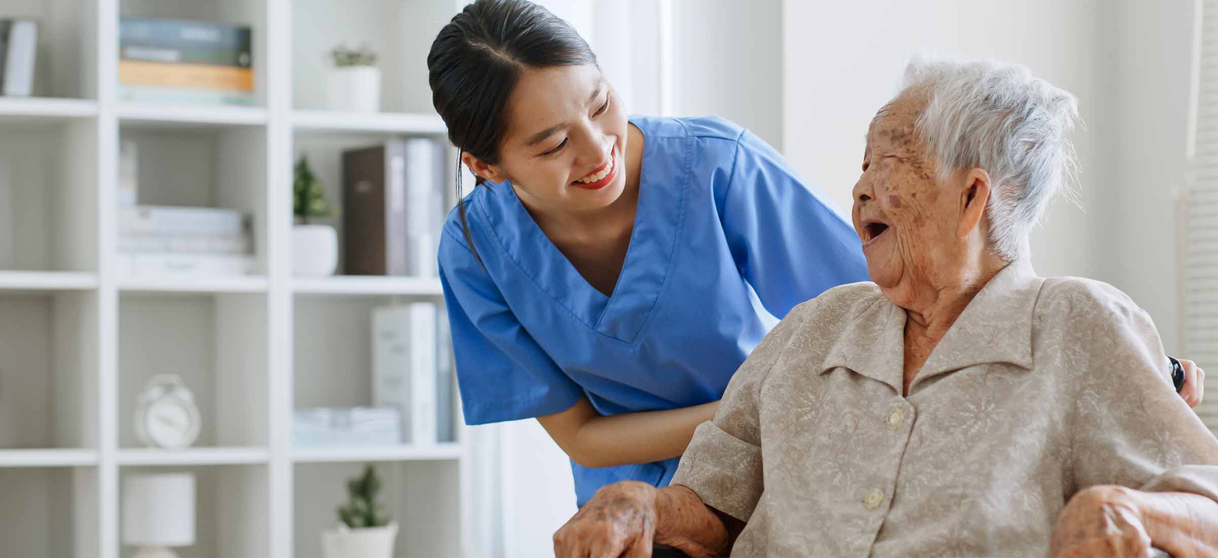 a woman in her wheelchair and her nurse