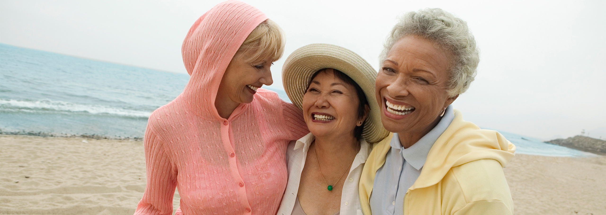 image of three older women together on a beach