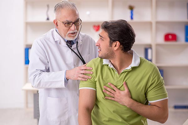 Patient in green shirt with a doctor
