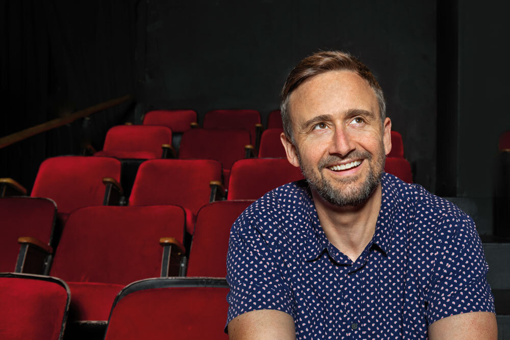 Aortic dissection patient Eli Newell sits in a row of velvet theater seats