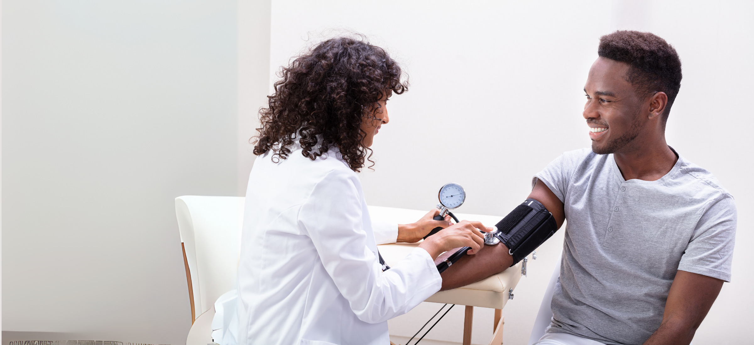 Person getting their blood pressure checked by a doctor