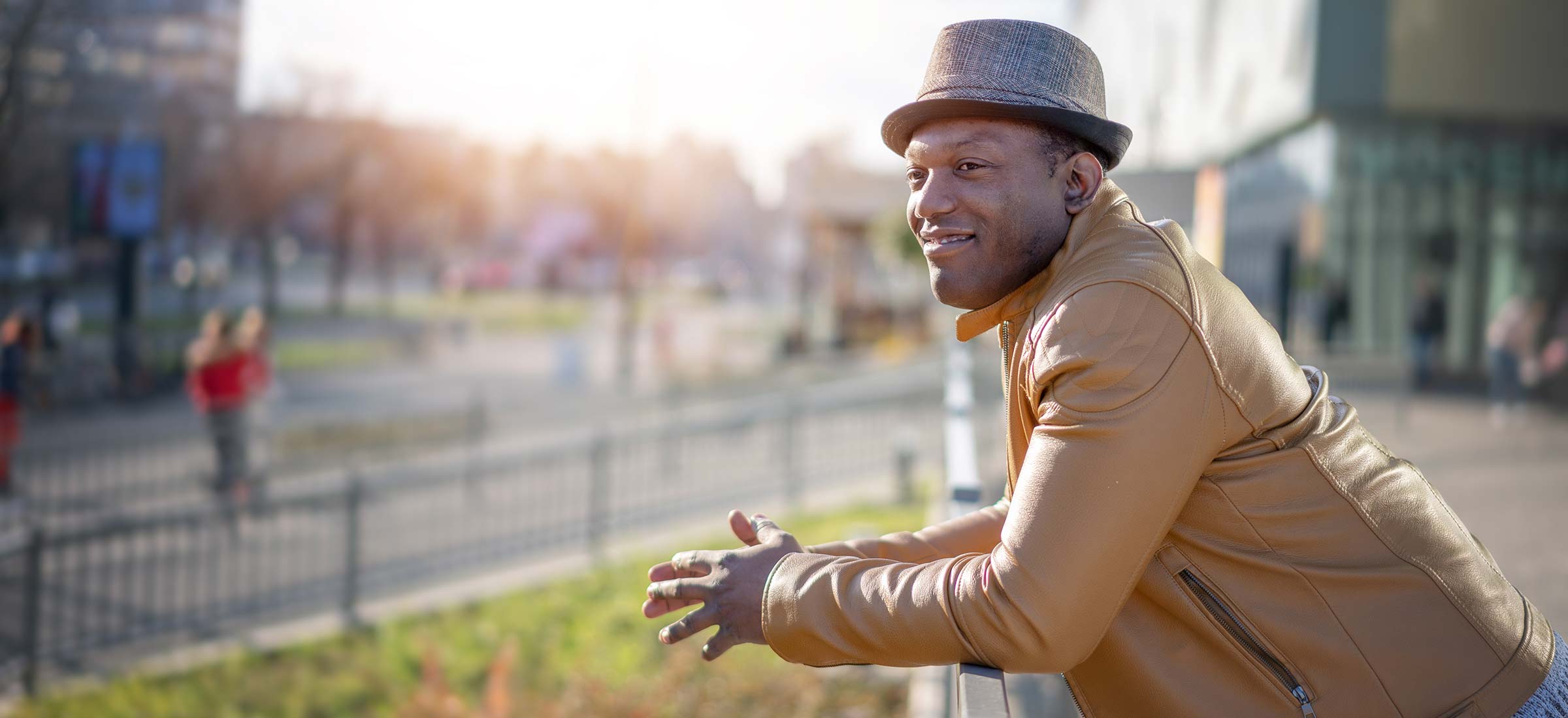 Person smiling while leaning over a fence