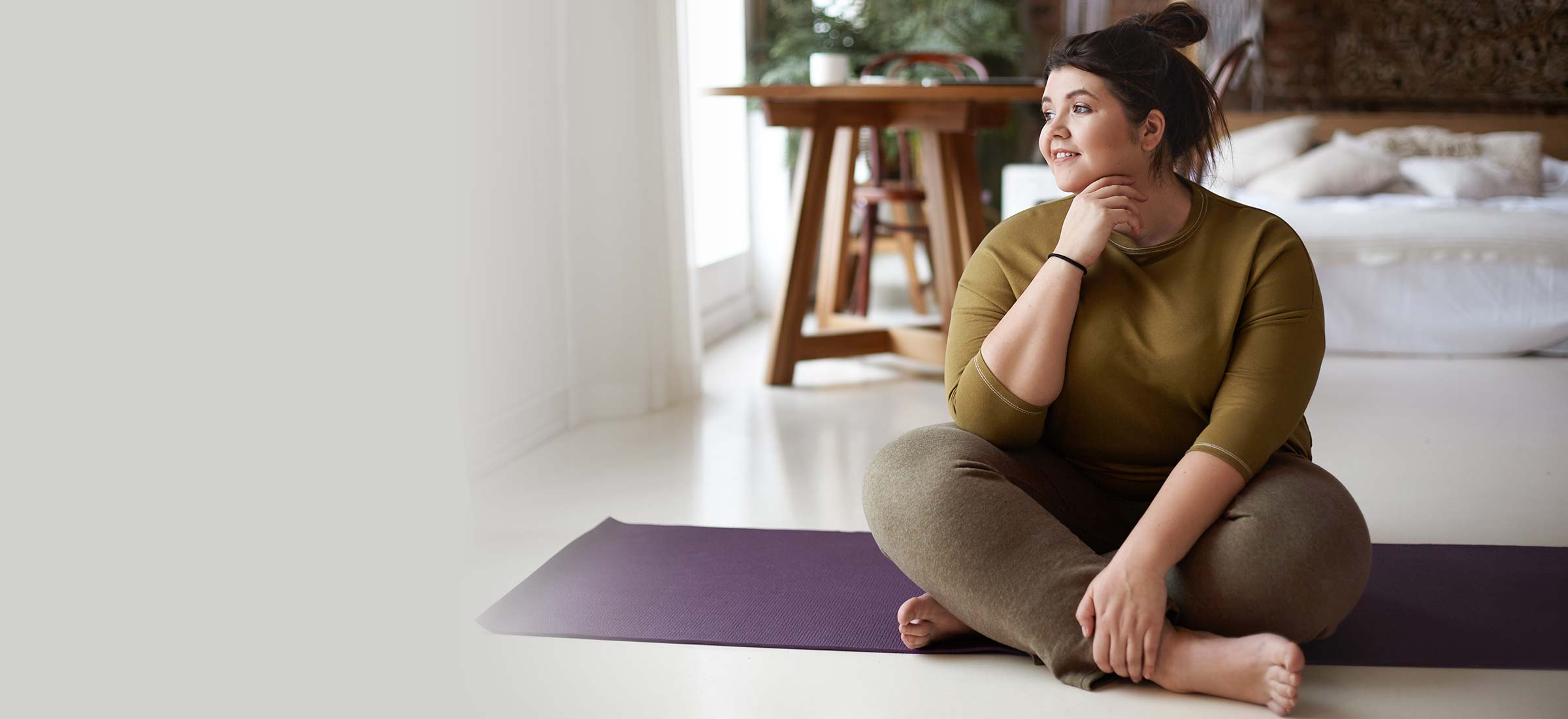 Person sitting on a yoga mat