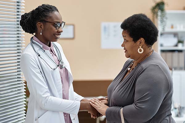 Physician holding a patient's hand