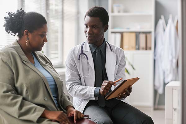 Patient sitting next to a physician