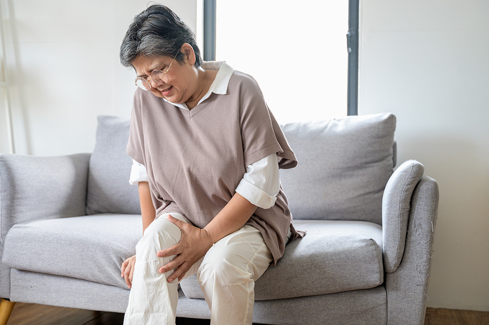 Senior woman suffering knee pain needs a knee replacement.