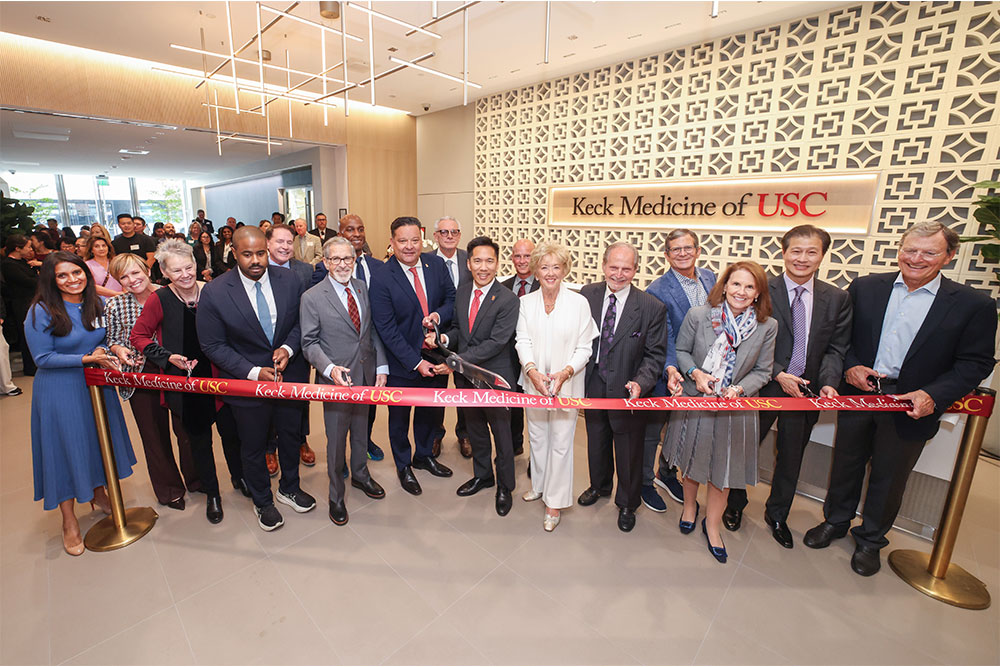 group of people cut a ribbon at ribbon-cutting ceremony for new building.