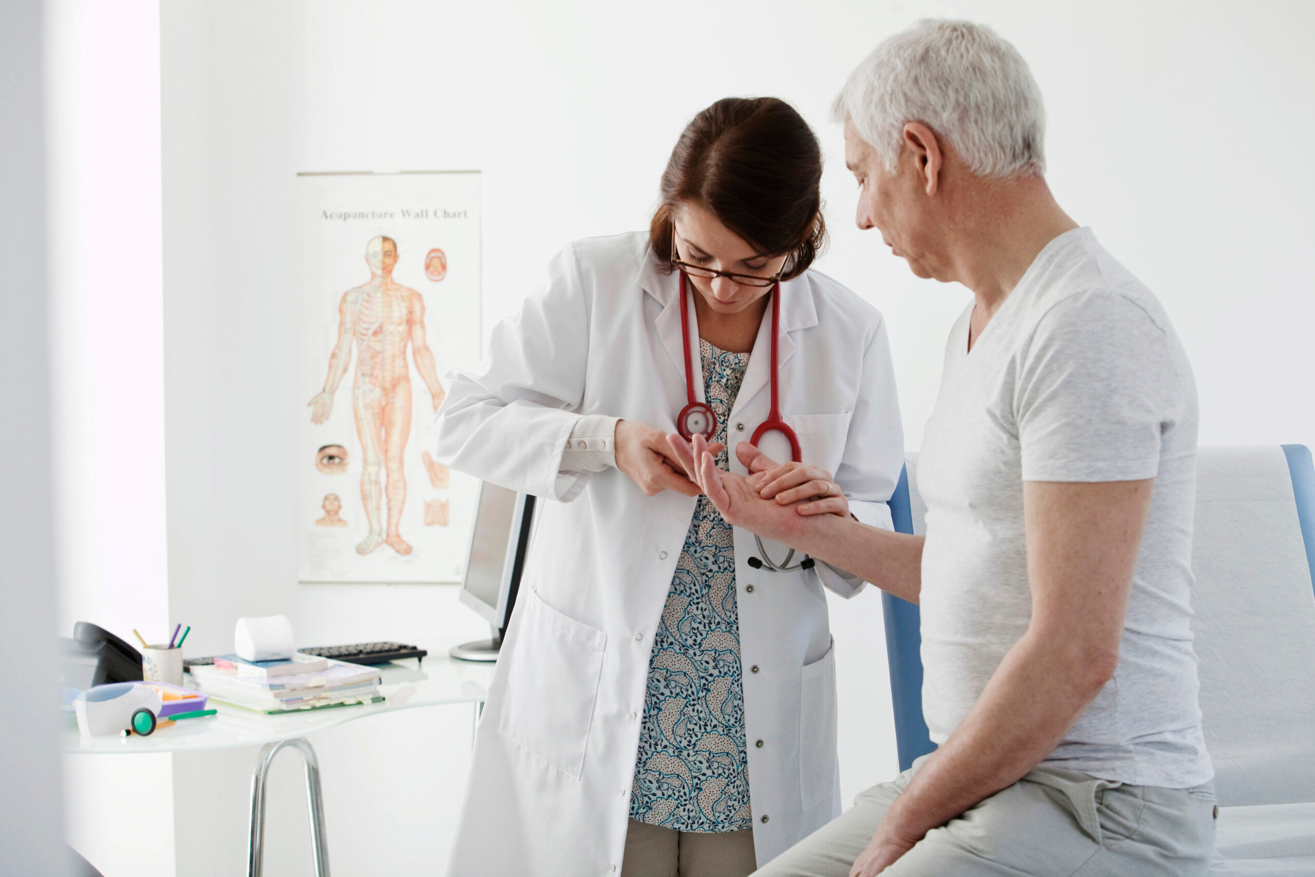 Image of a physician examining a patient hand and joints