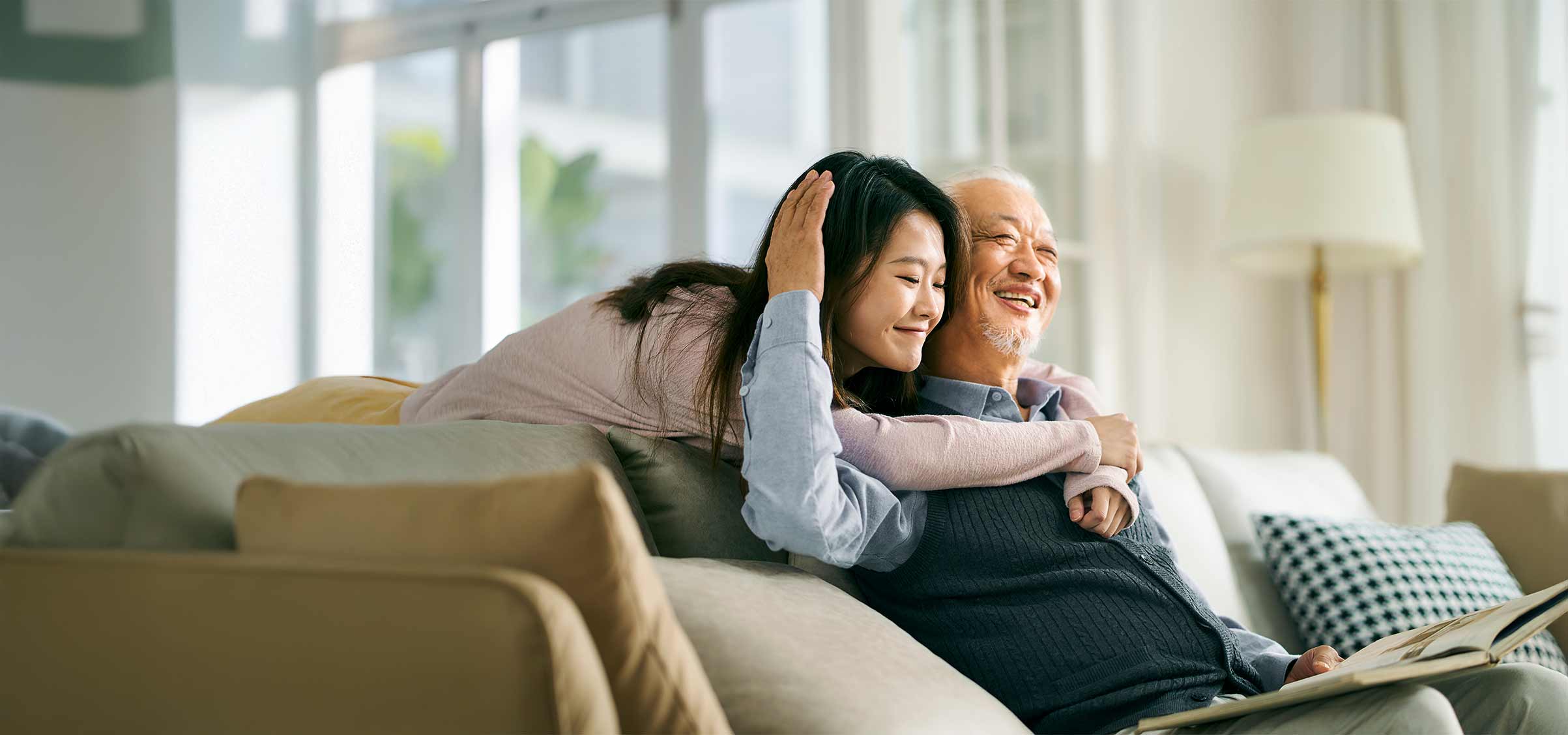 Asian elderly father and adult daughter having a good time.