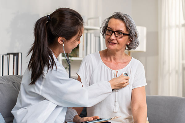 A woman gets her heart checked by her doctor.