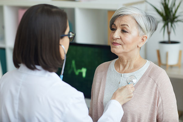 A woman gets checked by a doctor.
