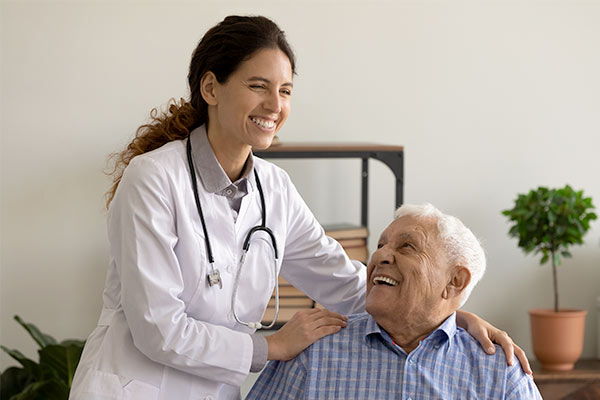 A doctor touches a patient who is considering left atrial appendage occlusion.