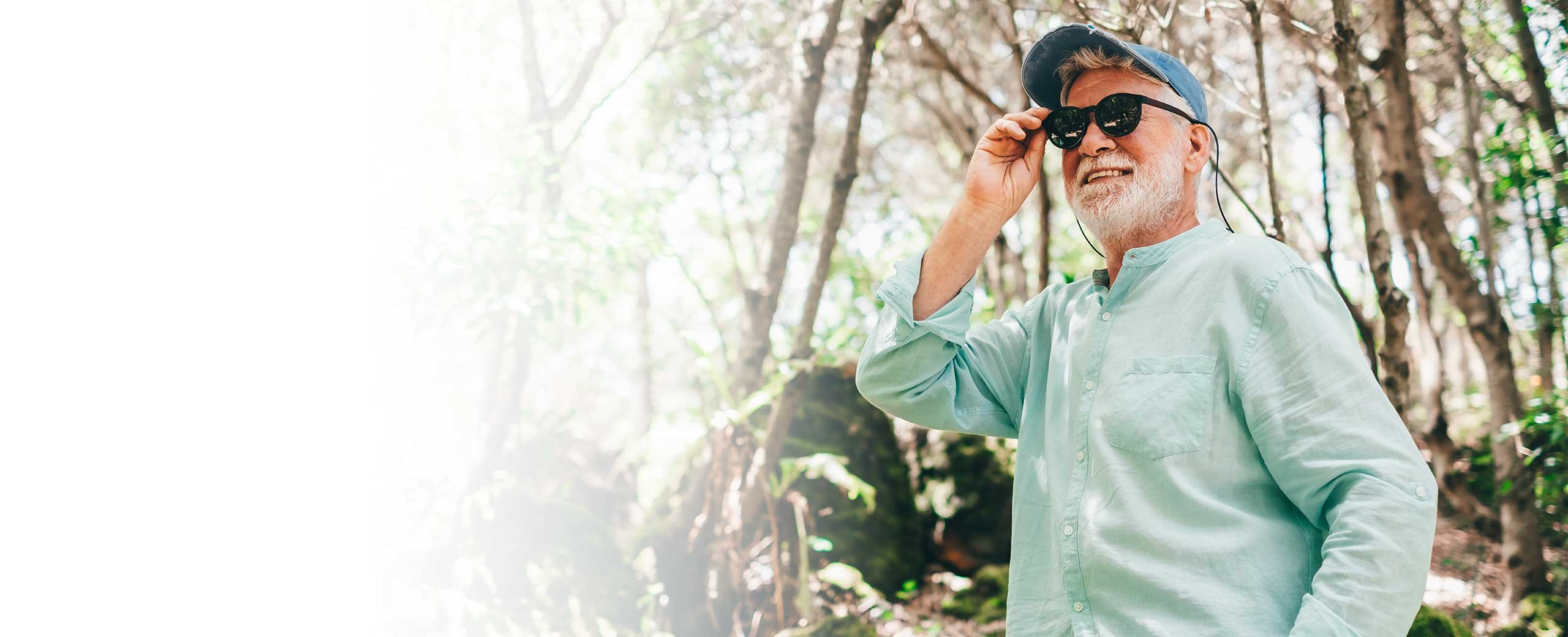 A man wears sunglasses while hiking.