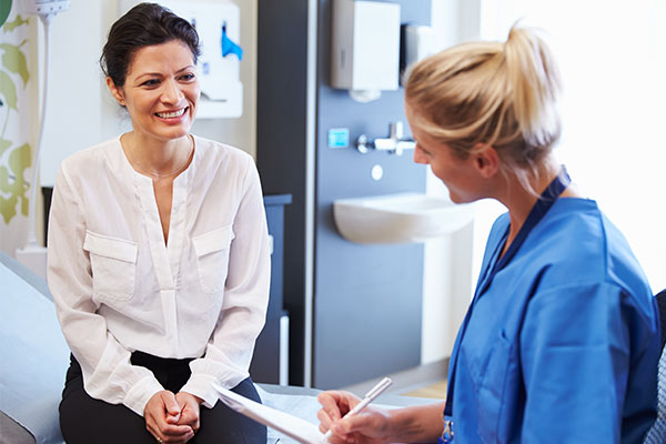 A woman talks to a doctor.